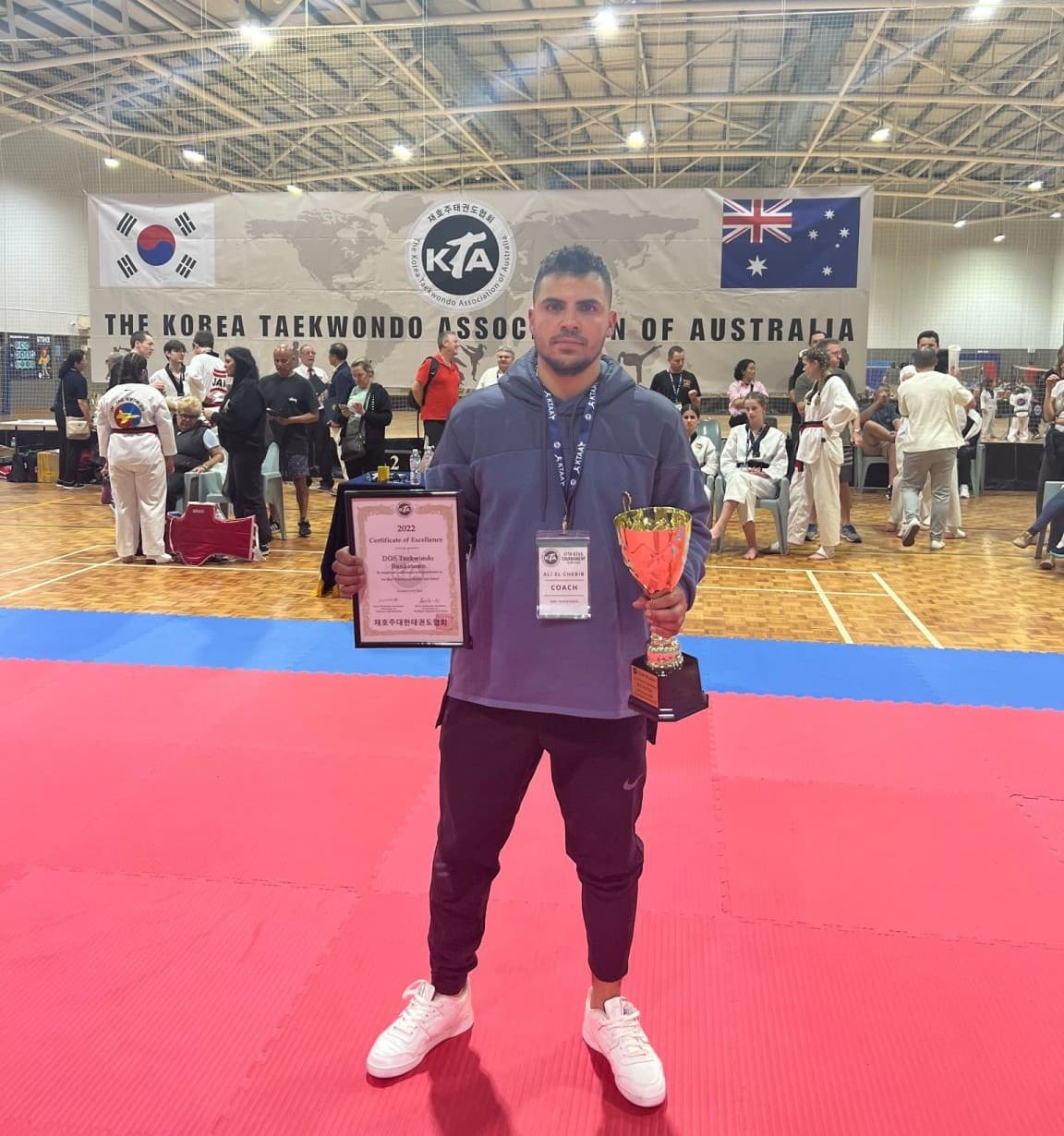 Master Ali with award at a Korea Taekwondo Association of Australia event